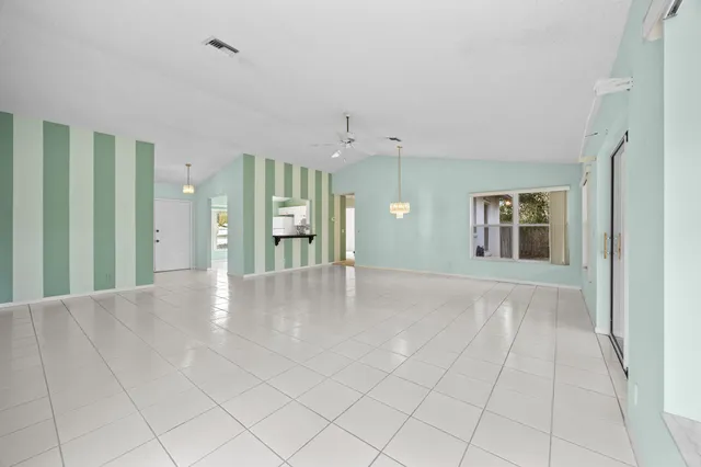 an empty room with windows and entrance