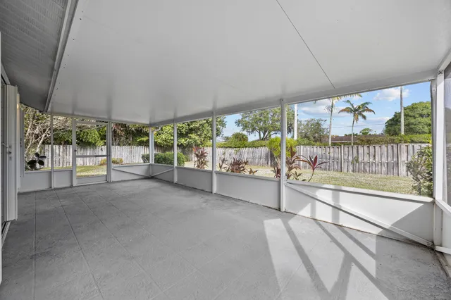 an aerial view of a house with a yard and large trees