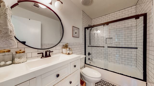 a bathroom with a sink mirror toilet and shower