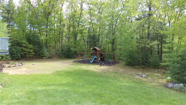 70 Frye Road Bolton, MA 01740 - Photo 3 of 27 a view of a backyard with a bench and a tree
