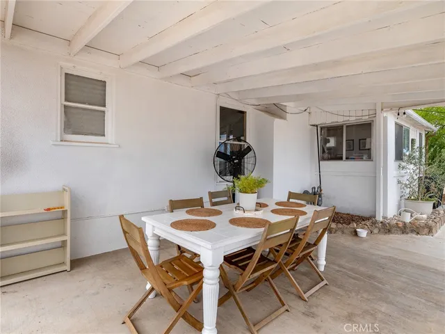 a view of a dining room with furniture and window