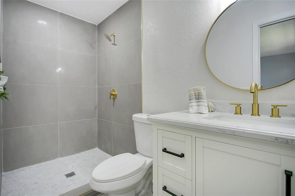 1914 Bonanza Court Winter Park, FL 32792 - Photo 13 of 33 a bathroom with a sink a toilet and a mirror