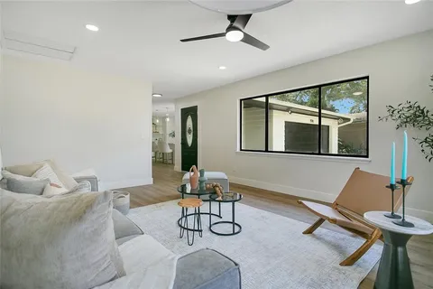 a living room with furniture a window and gym equipment