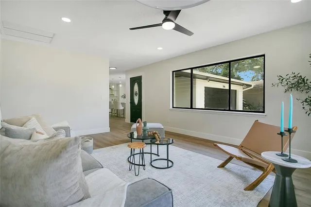 a living room with furniture a window and gym equipment