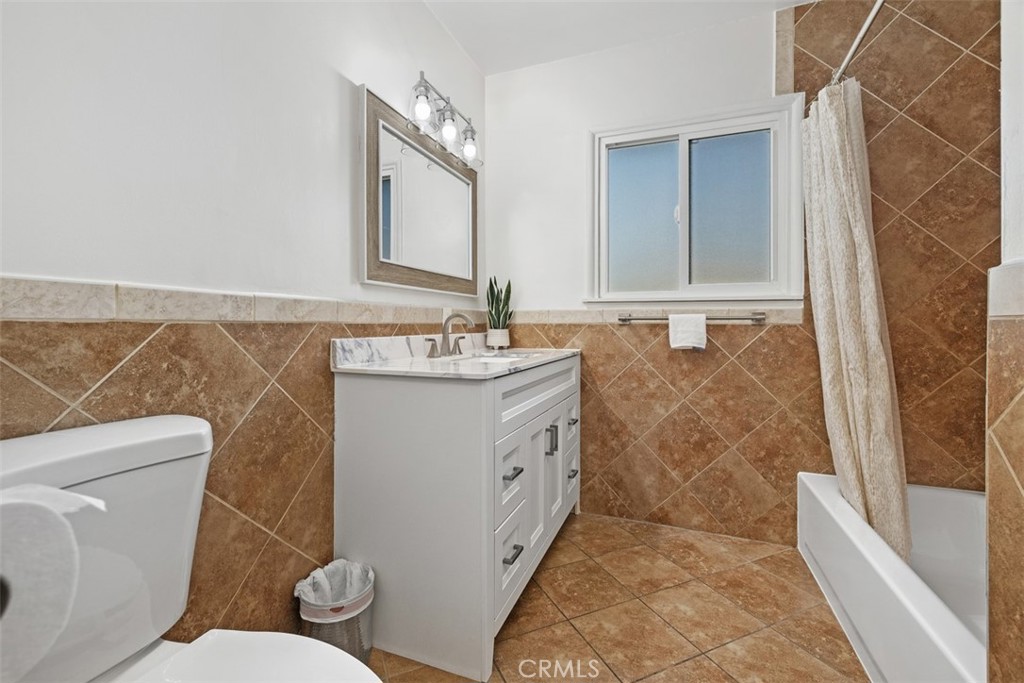 219 South Meadow Road West Covina, CA 91791 - Photo 12 of 26 a spacious bathroom with a sink a toilet a mirror and bathtub