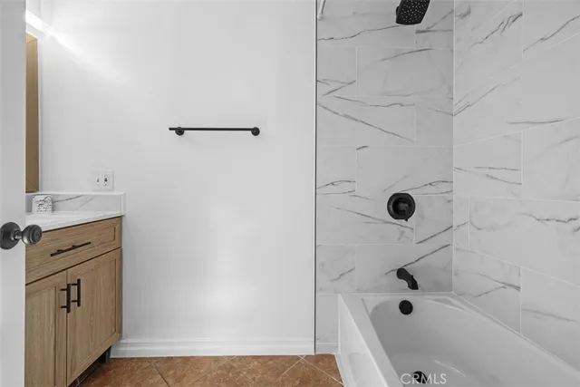 a bathroom with a bathtub and shower