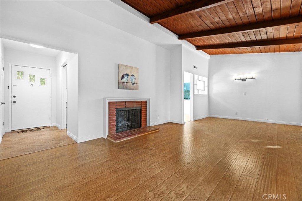 219 South Meadow Road West Covina, CA 91791 - Photo 4 of 26 a view of empty room with wooden floor and fireplace