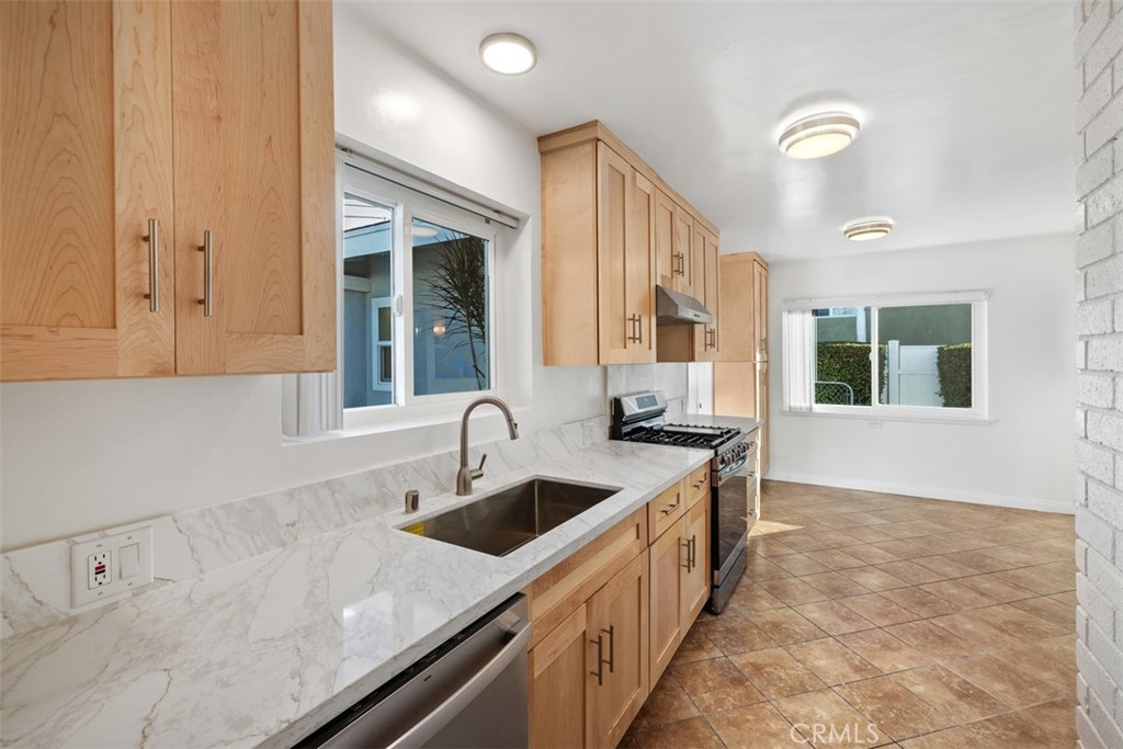 219 South Meadow Road West Covina, CA 91791 - Photo 7 of 26 a kitchen that has a sink and a stove in it