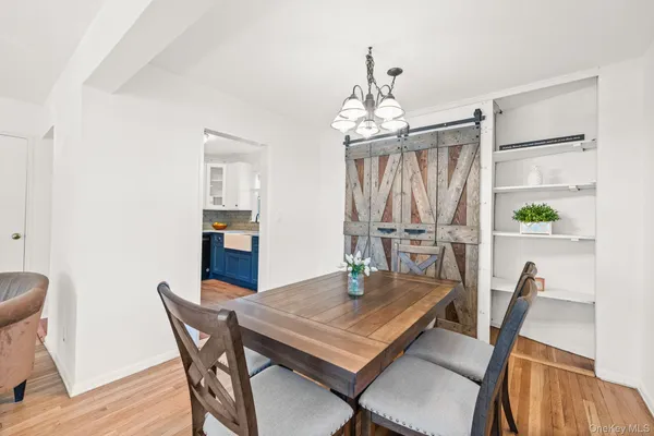 a view of a dining room with furniture and a chandelier