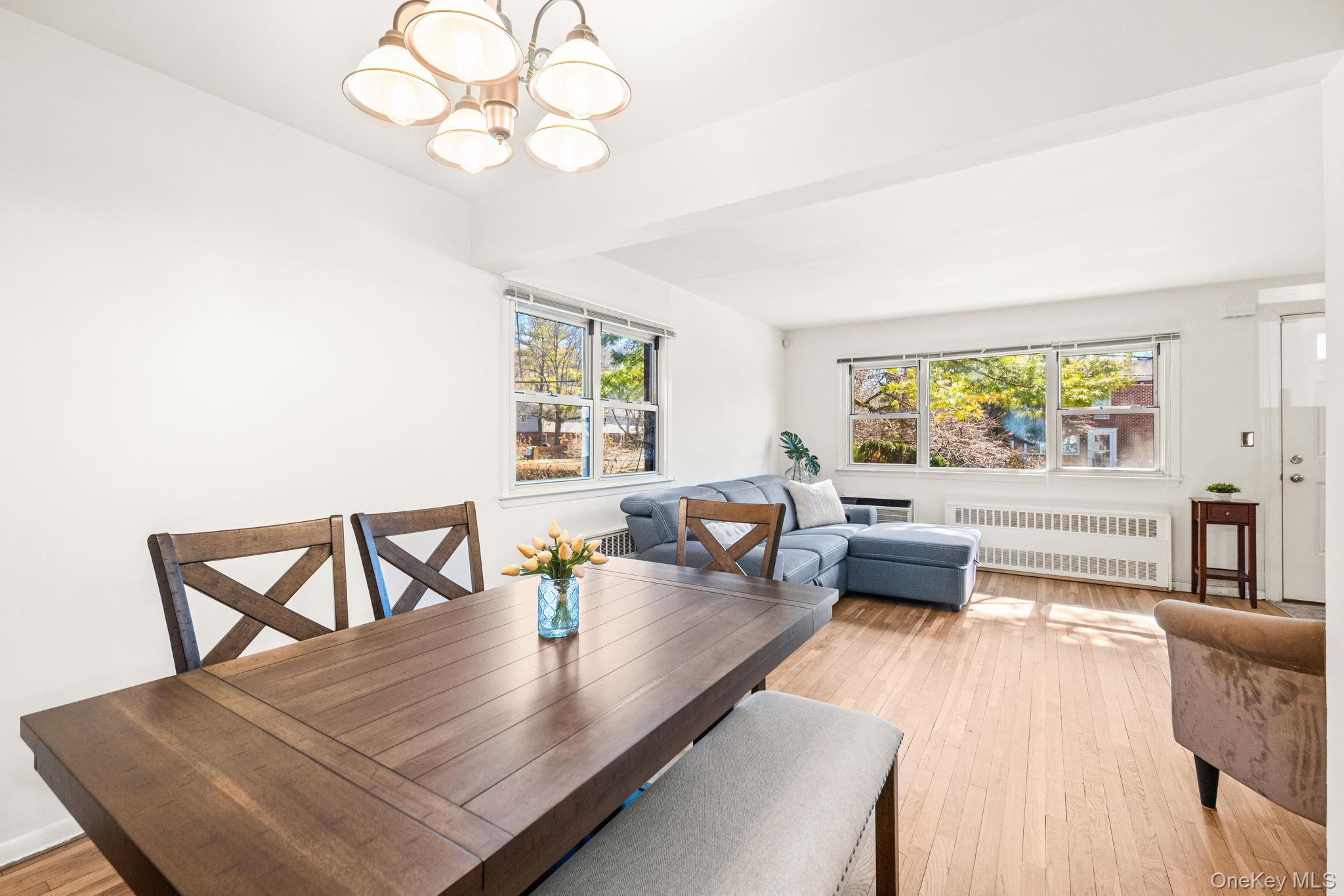 9 Geneva Road, Unit 9 Ossining, NY 10562 - Photo 13 of 26 a view of a dining room with furniture a chandelier and wooden floor