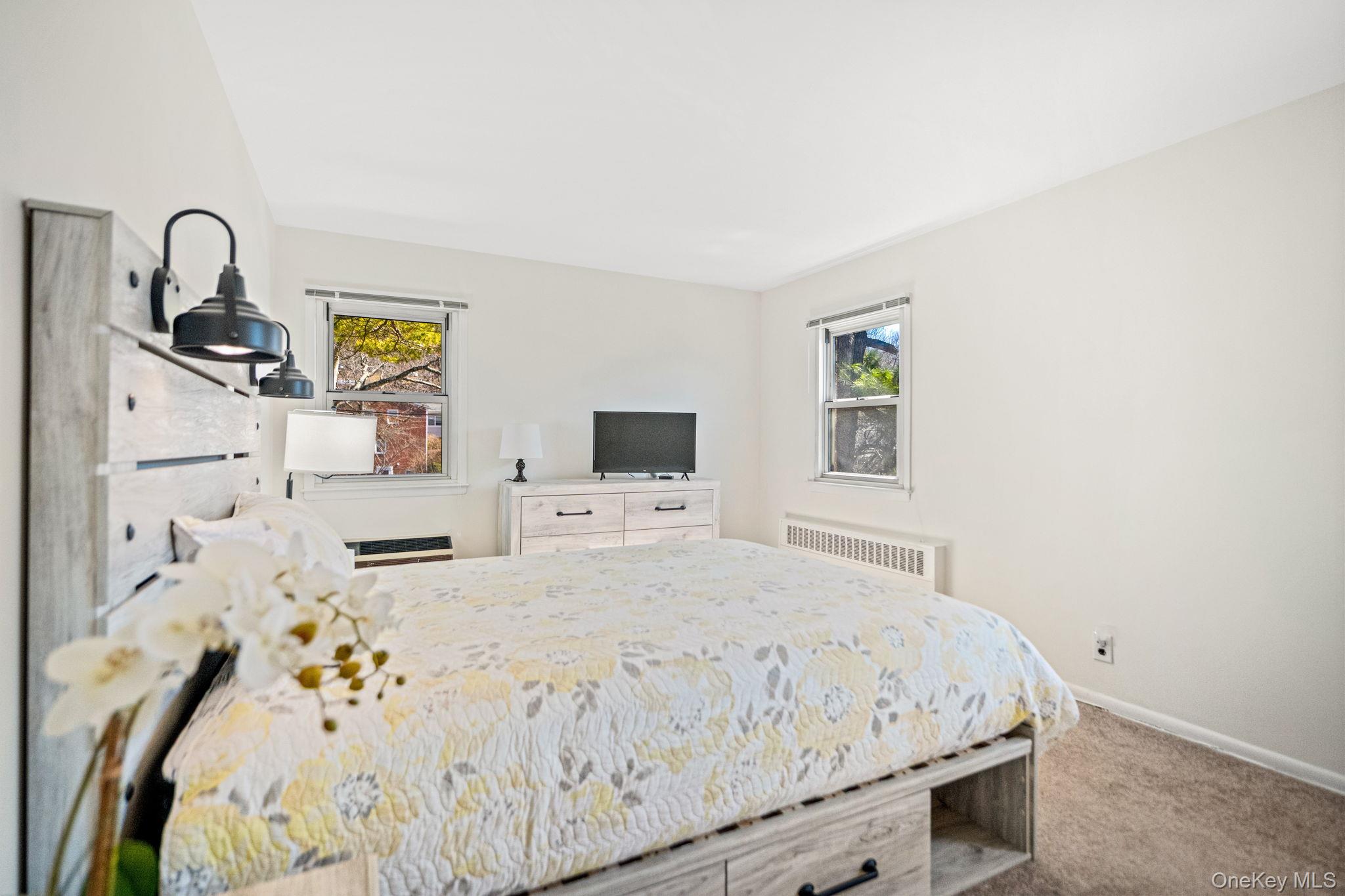 9 Geneva Road, Unit 9 Ossining, NY 10562 - Photo 16 of 26 a bedroom with a bed and a dresser