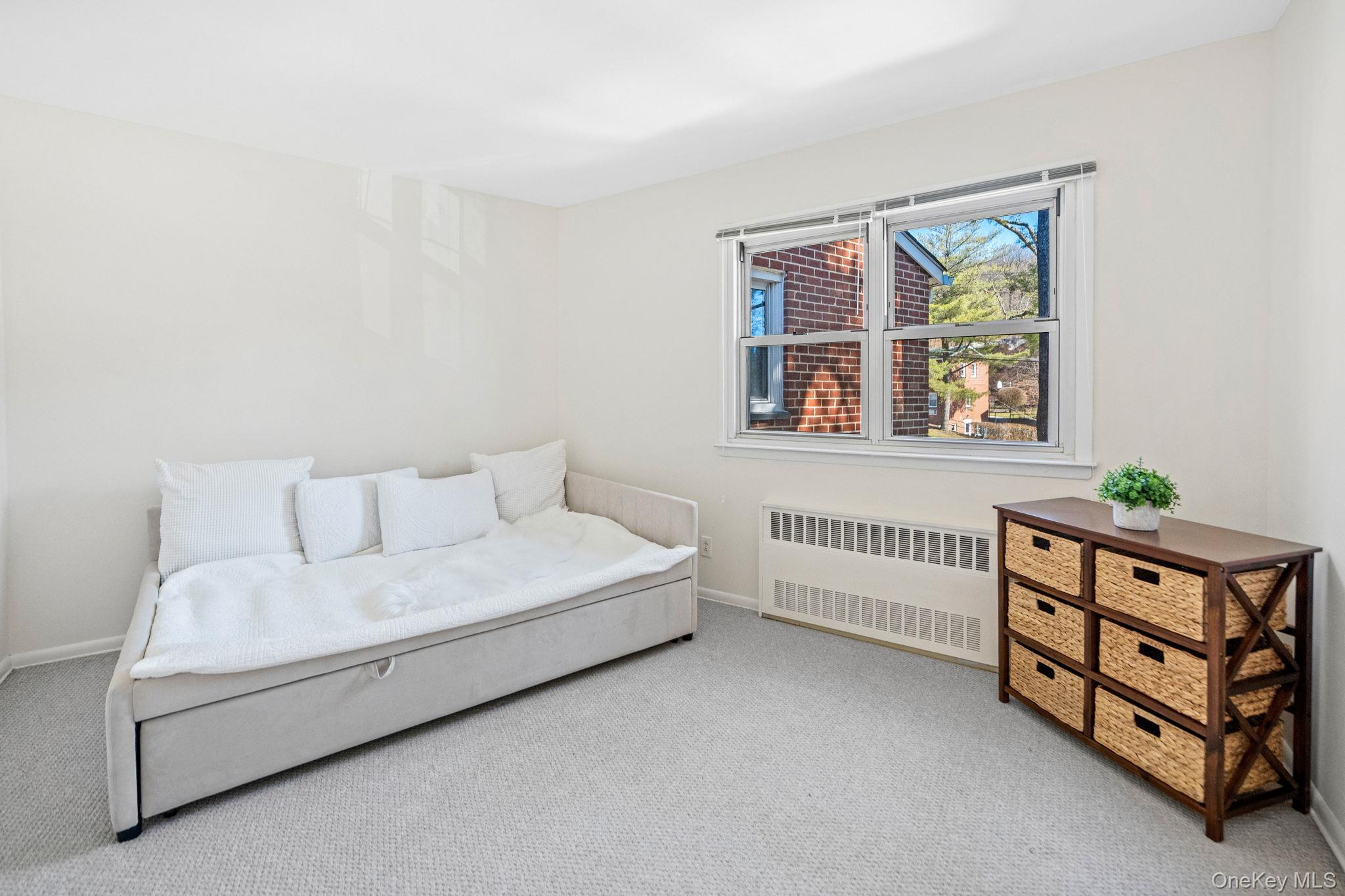 9 Geneva Road, Unit 9 Ossining, NY 10562 - Photo 18 of 26 a room with a bed and a window