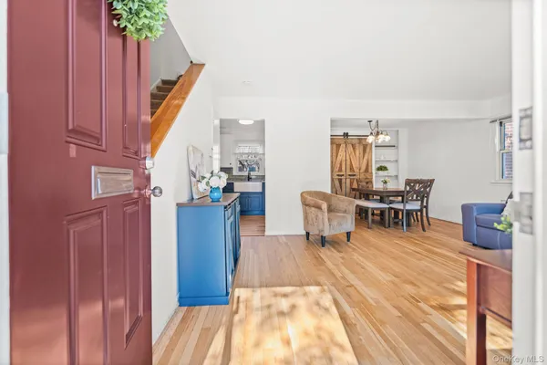 a dining room with furniture and wooden floor