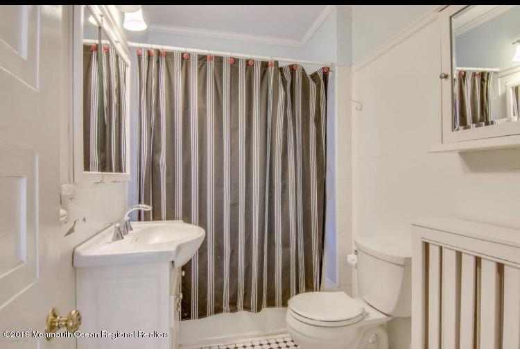 102 Lake Drive Allenhurst, NJ 07711 - Photo 12 of 14 a bathroom with a sink a toilet and shower curtain