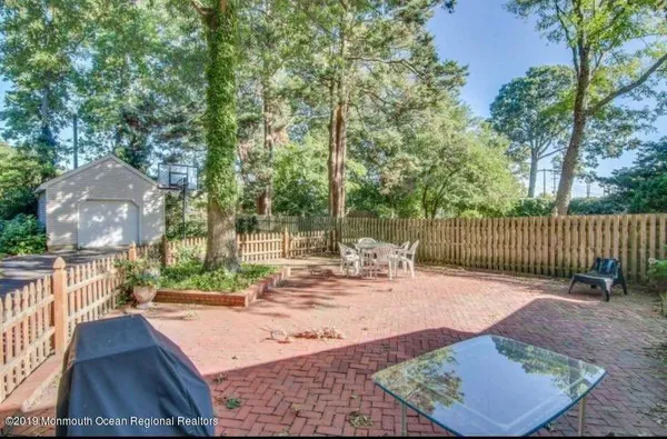 a view of a backyard with sitting area