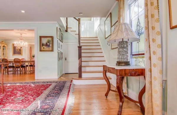 a view of entryway with livingroom and wooden floor