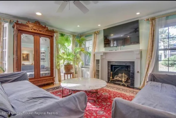 a living room with furniture and a fireplace