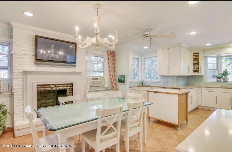 102 Lake Drive Allenhurst, NJ 07711 - Photo 8 of 14 a open kitchen with granite countertop a stove top oven a sink a window and chairs