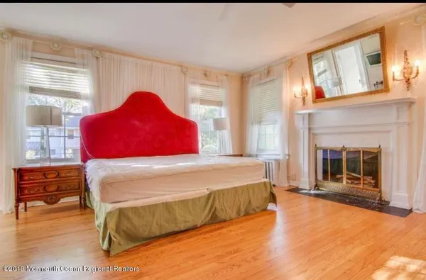 a bedroom with a bed and a fireplace