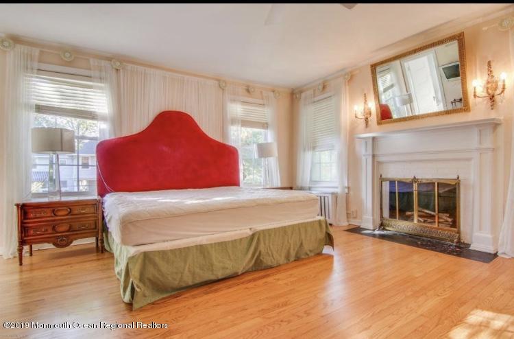 102 Lake Drive Allenhurst, NJ 07711 - Photo 9 of 14 a bedroom with a bed and a fireplace