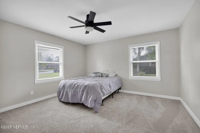 a bed room with a bed and a window