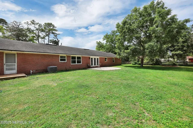 a view of house with yard and entertaining space