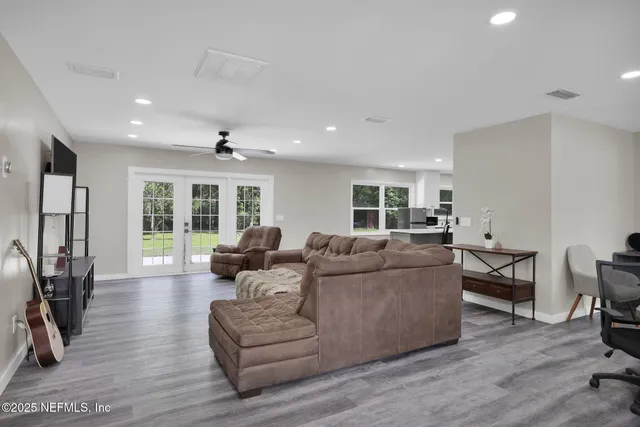 a living room with furniture and a wooden floor
