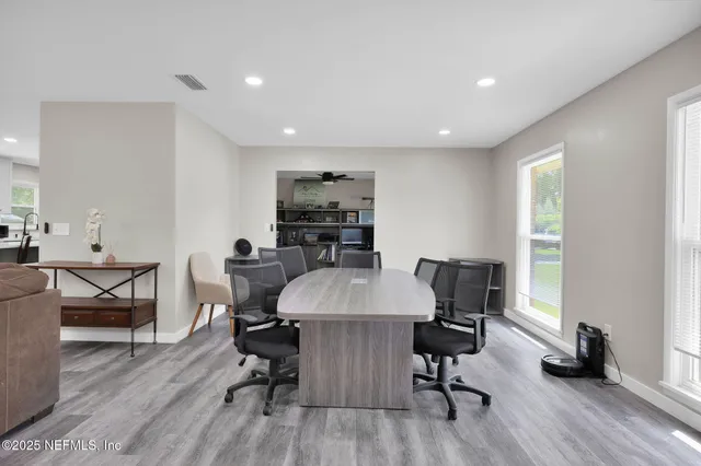 a view of a dining room with furniture and wooden floor