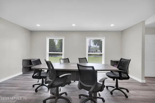 a view of a workspace with furniture and a window