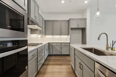 a kitchen with a sink stove and microwave