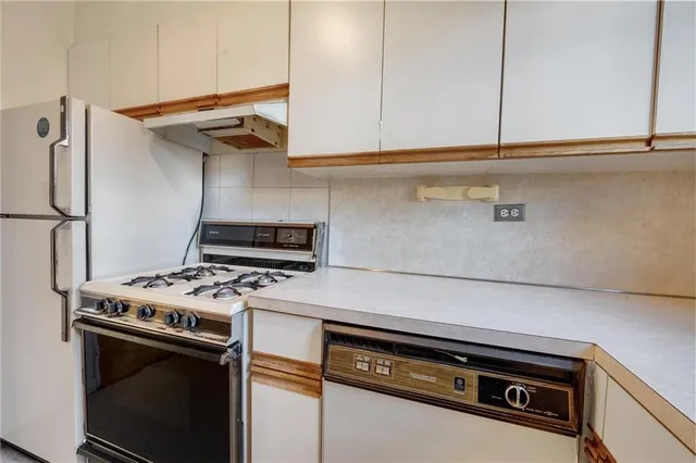a stove top oven sitting inside of a kitchen