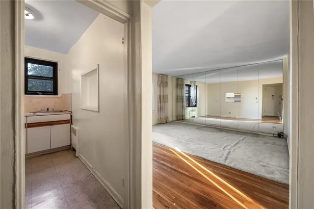 a view of a hallway with bathroom and bathroom