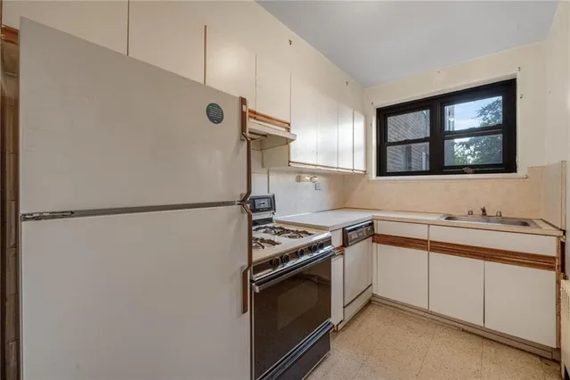 a kitchen with a refrigerator sink and stove