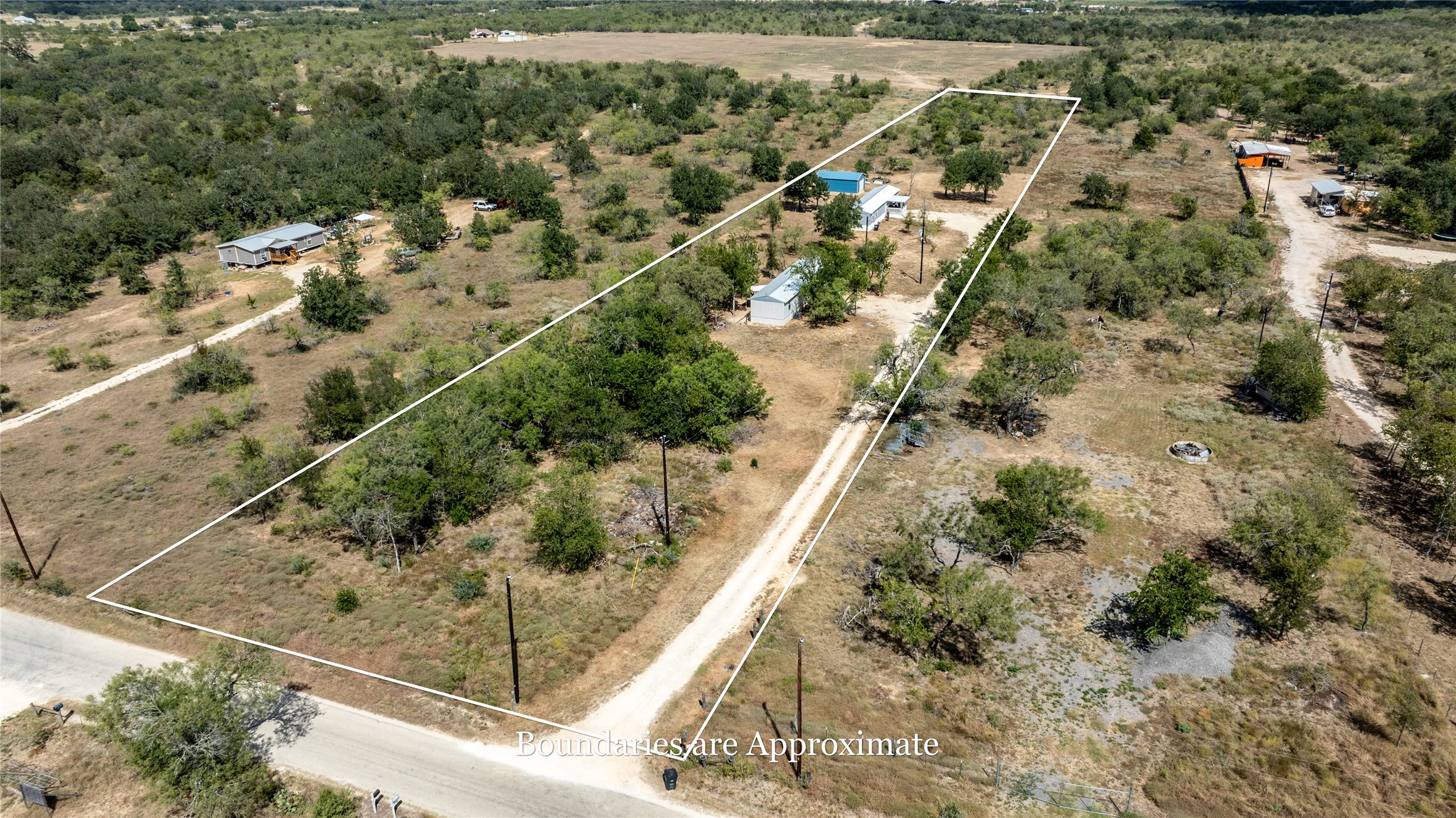 1265 Bugtussle Lane Lockhart, TX 78644 - Photo 1 of 16 a view of a yard with wooden fence