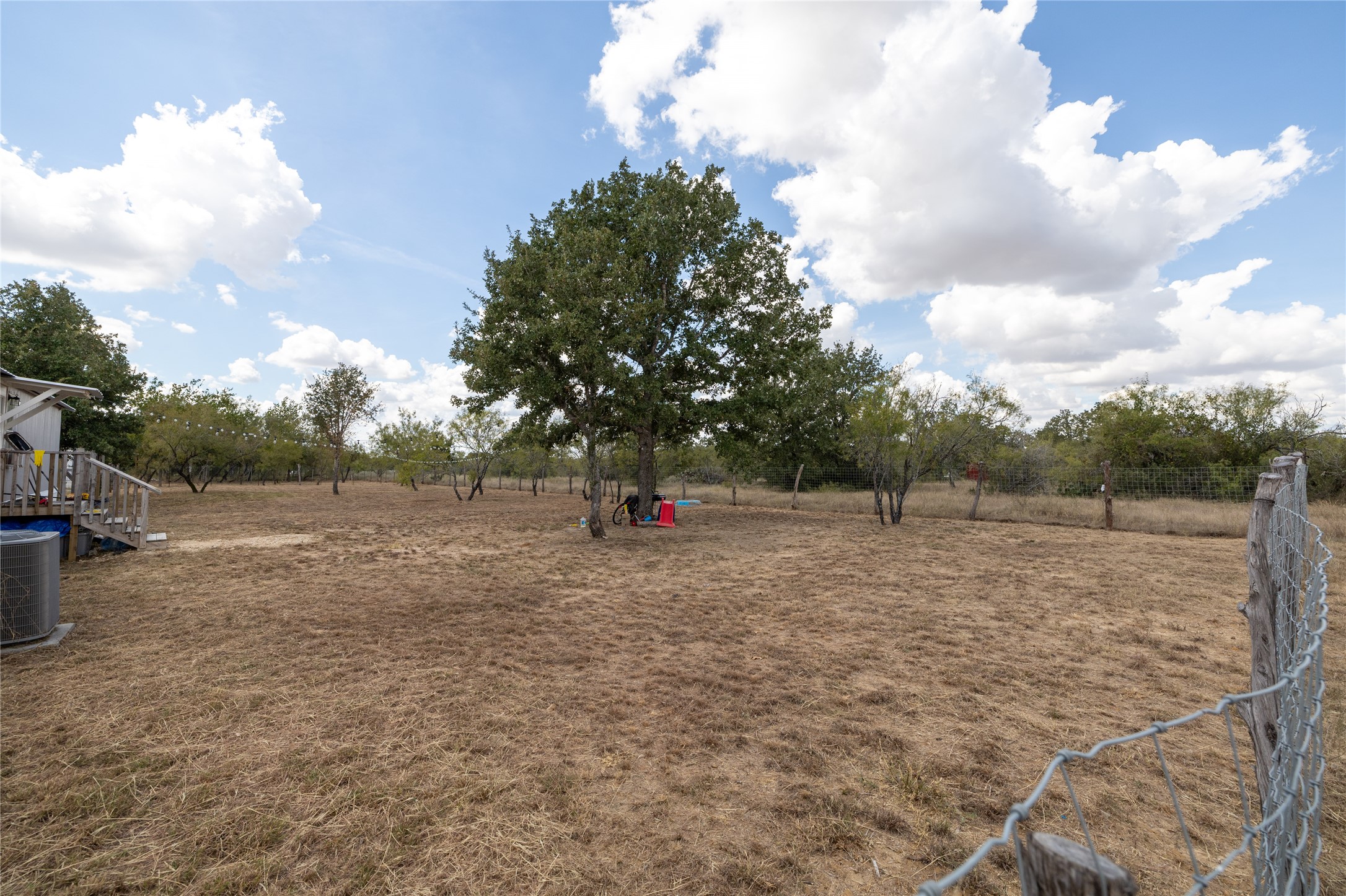 1265 Bugtussle Lane Lockhart, TX 78644 - Photo 13 of 16 a backyard of a house with lots of green space