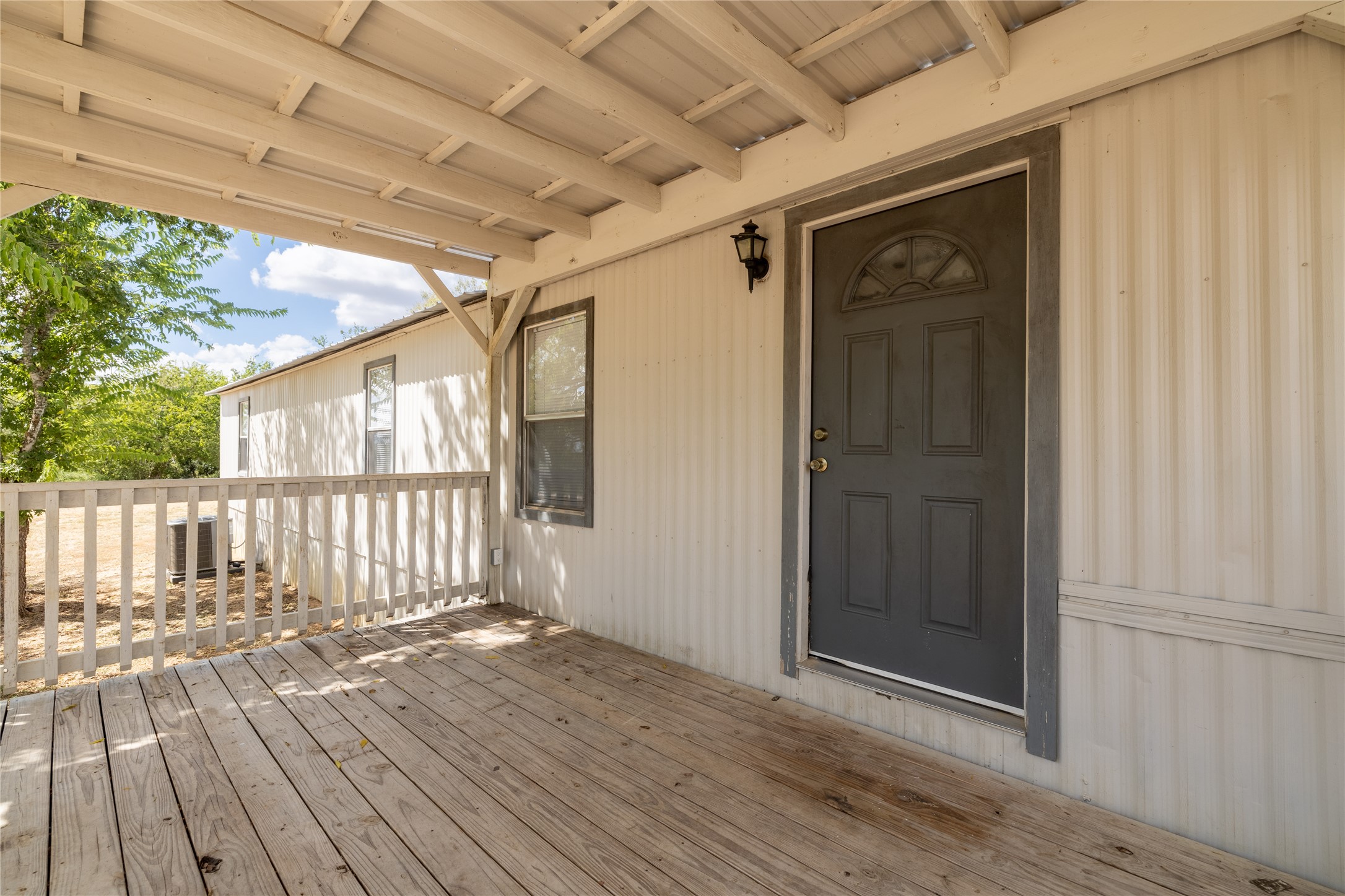 1265 Bugtussle Lane Lockhart, TX 78644 - Photo 2 of 16 an empty room with wooden floor and windows