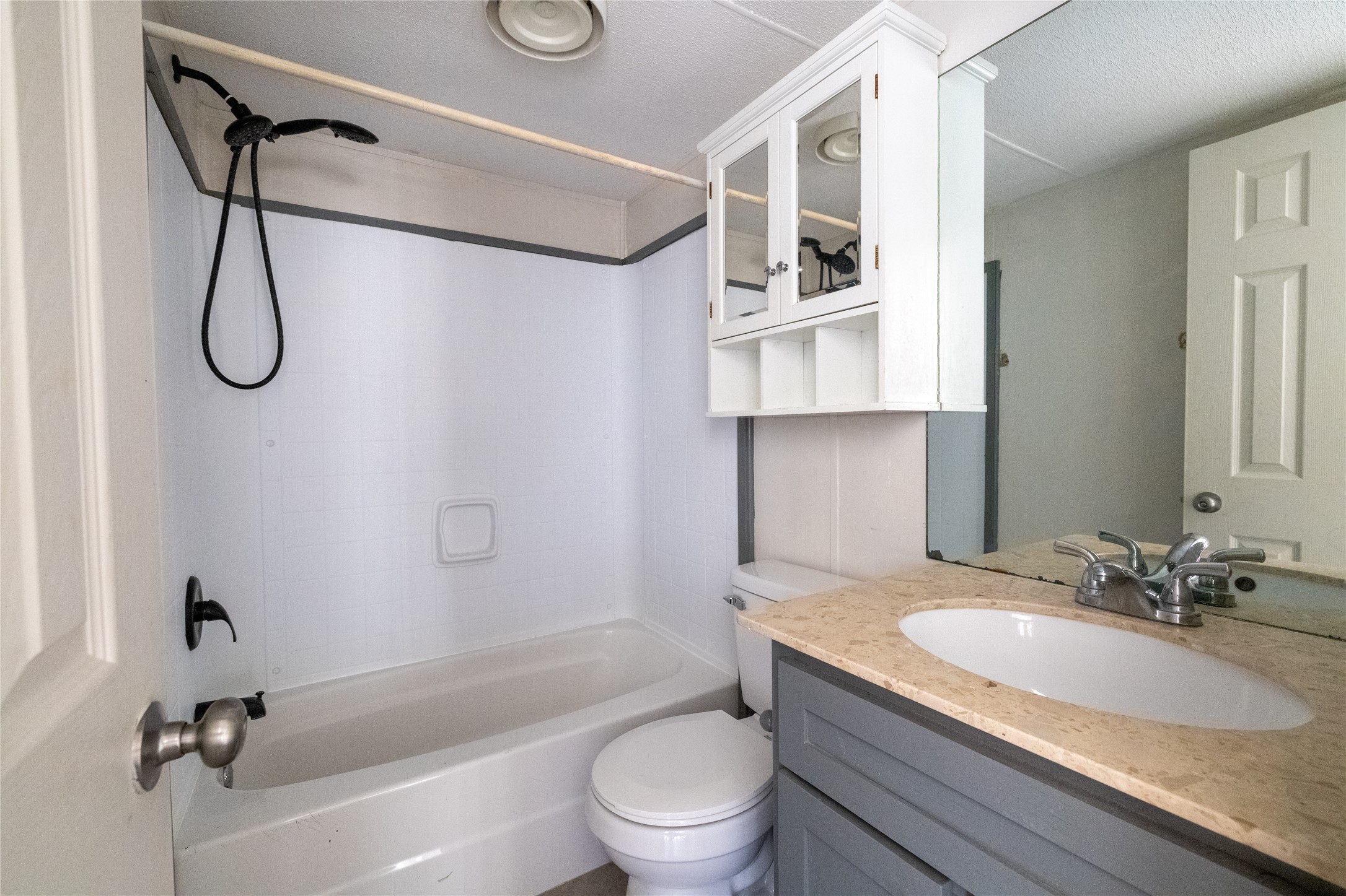 1265 Bugtussle Lane Lockhart, TX 78644 - Photo 7 of 16 a bathroom with a granite countertop sink a toilet and a bathtub