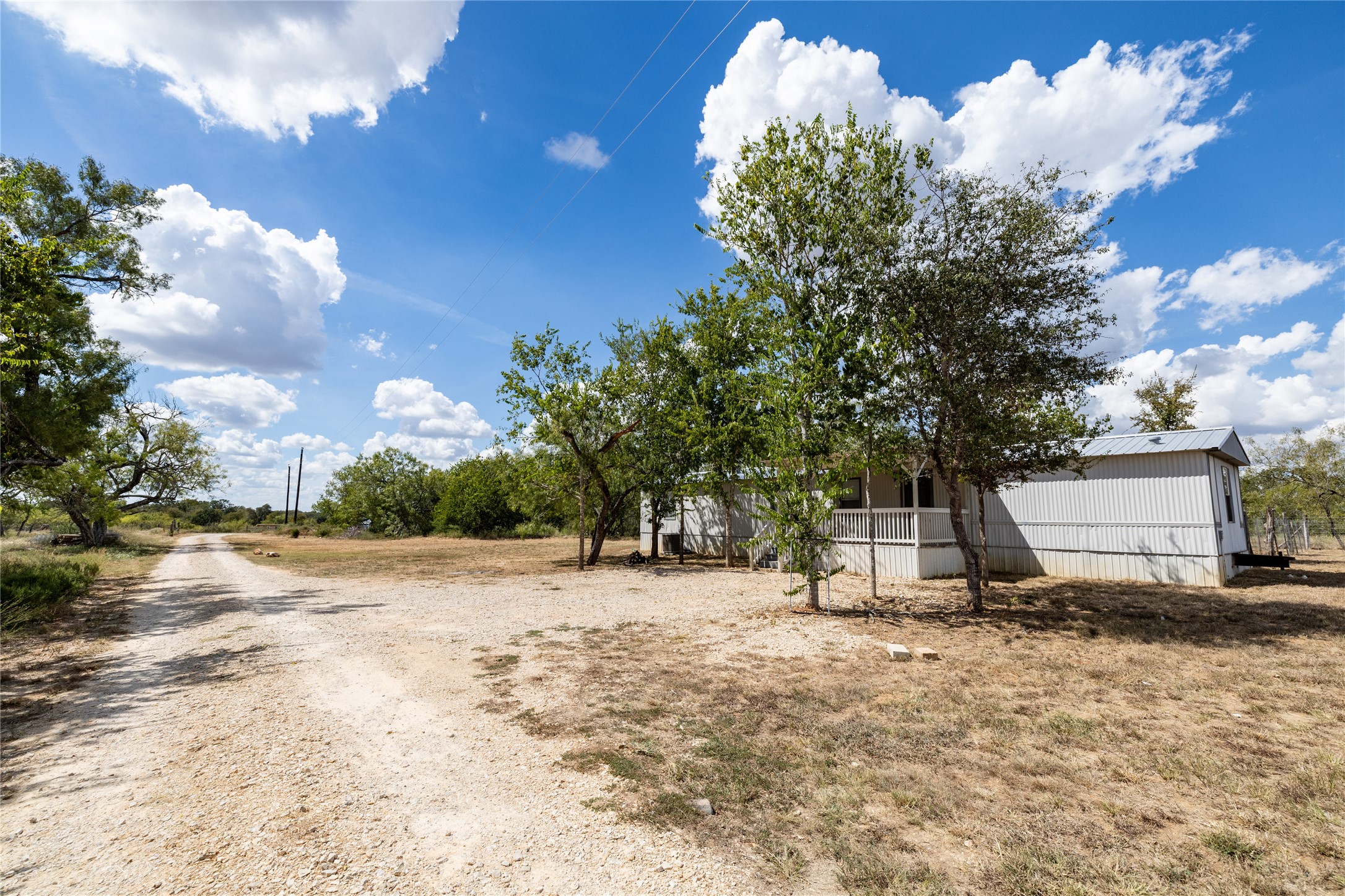 1265 Bugtussle Lane Lockhart, TX 78644 - Photo 9 of 16 a backyard of a house with lots of green space