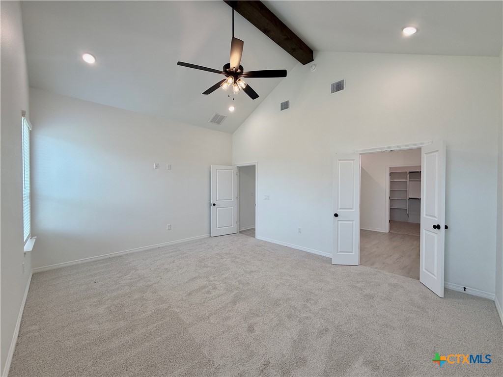 2016 Yarrow Road Temple, TX 76502 - Photo 22 of 30 an empty room with chandelier fan and windows