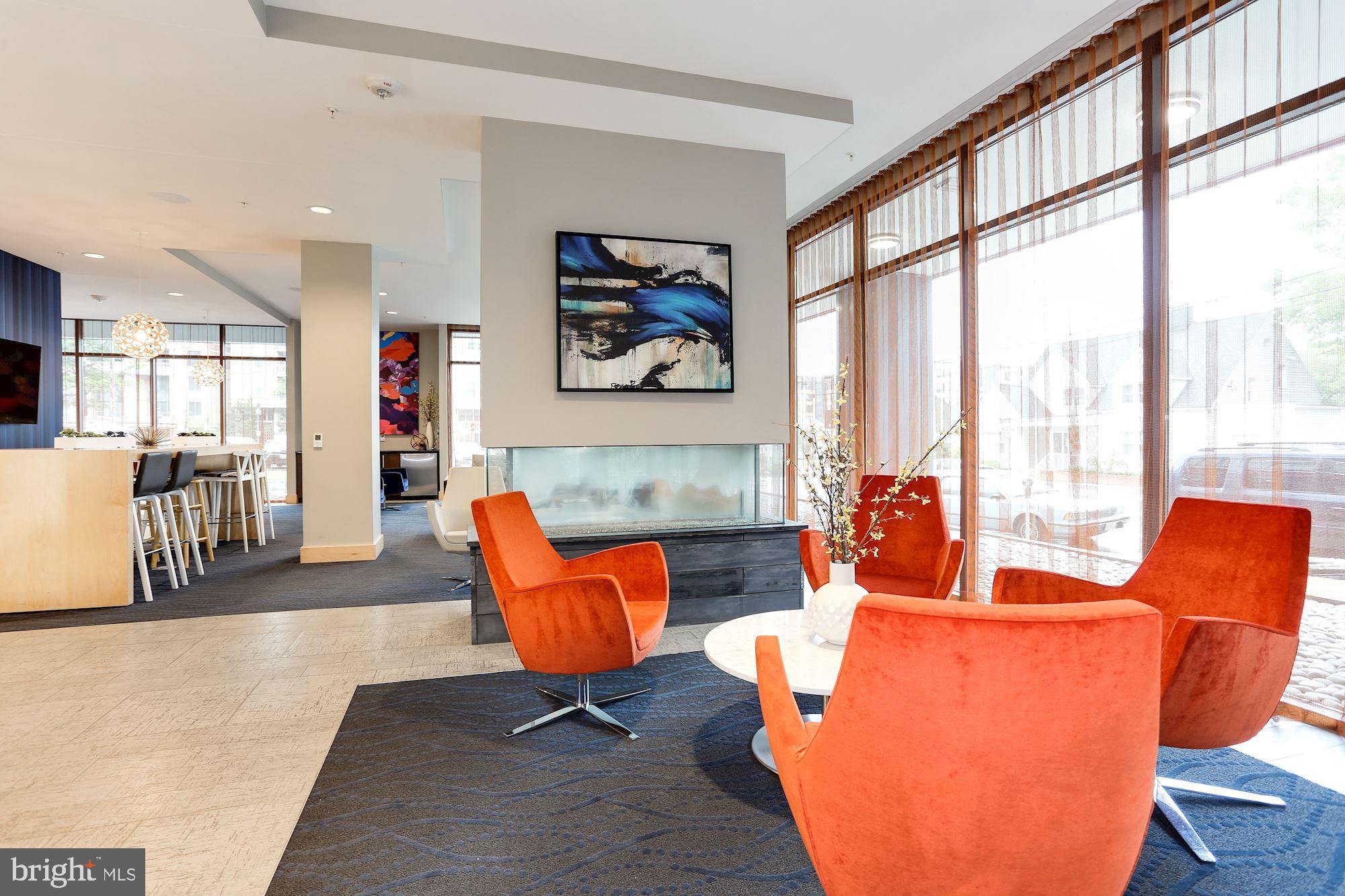 1320 Fenwick Lane, Unit 202 Silver Spring, MD 20910 - Photo 17 of 19 a living room with furniture and a large window