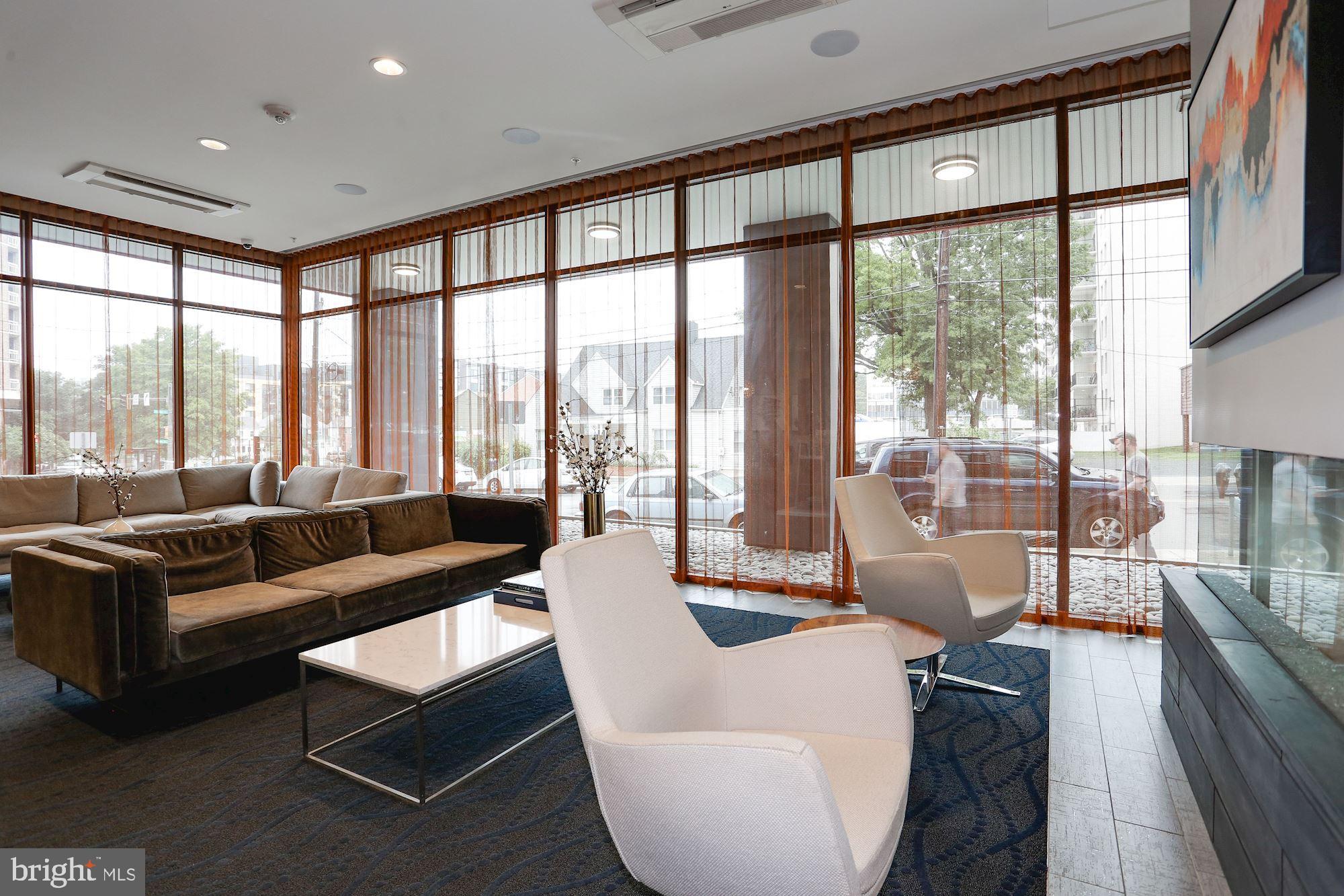 1320 Fenwick Lane, Unit 202 Silver Spring, MD 20910 - Photo 18 of 19 a living room with furniture and a large window