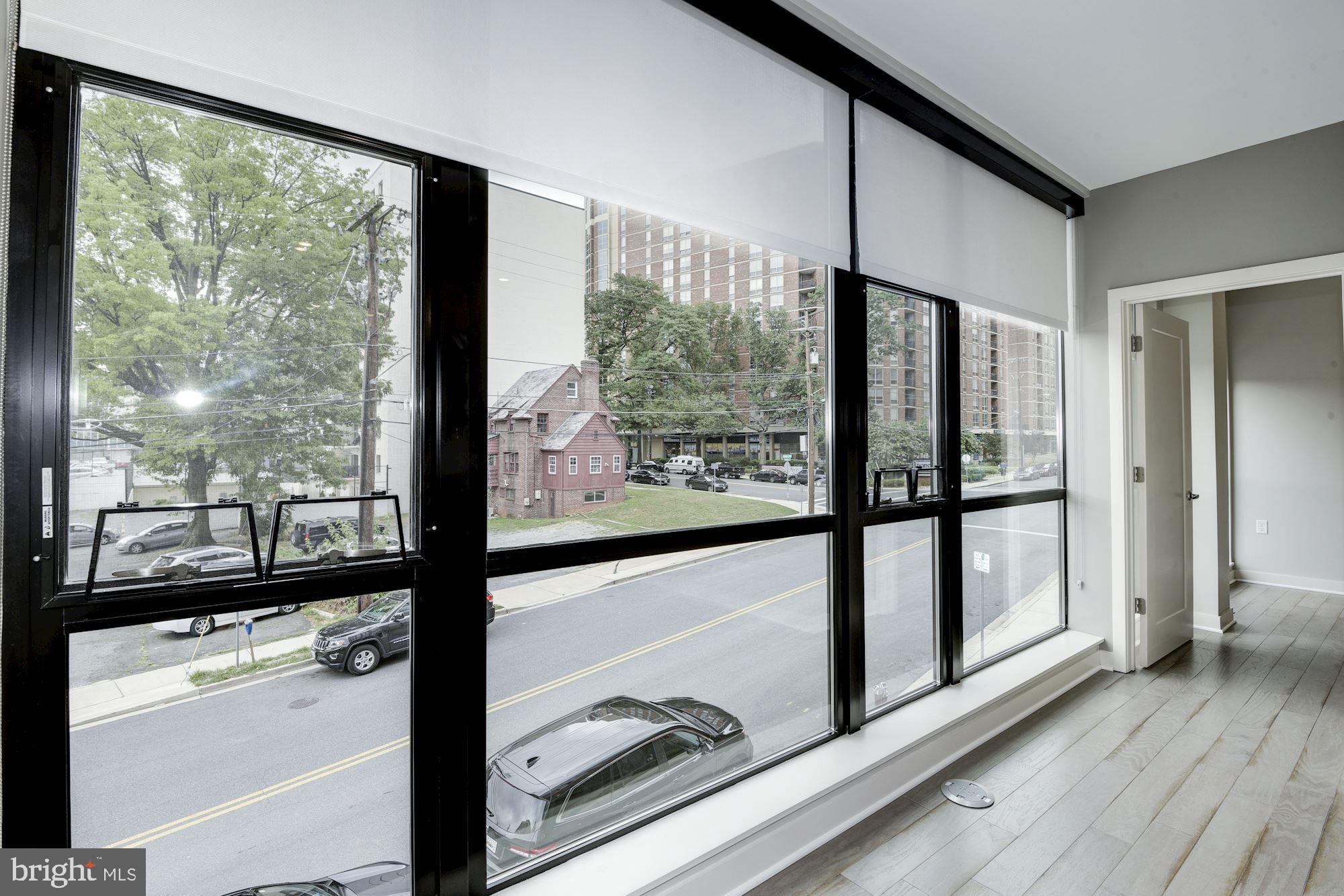 1320 Fenwick Lane, Unit 202 Silver Spring, MD 20910 - Photo 6 of 19 a view of a glass door with a large window