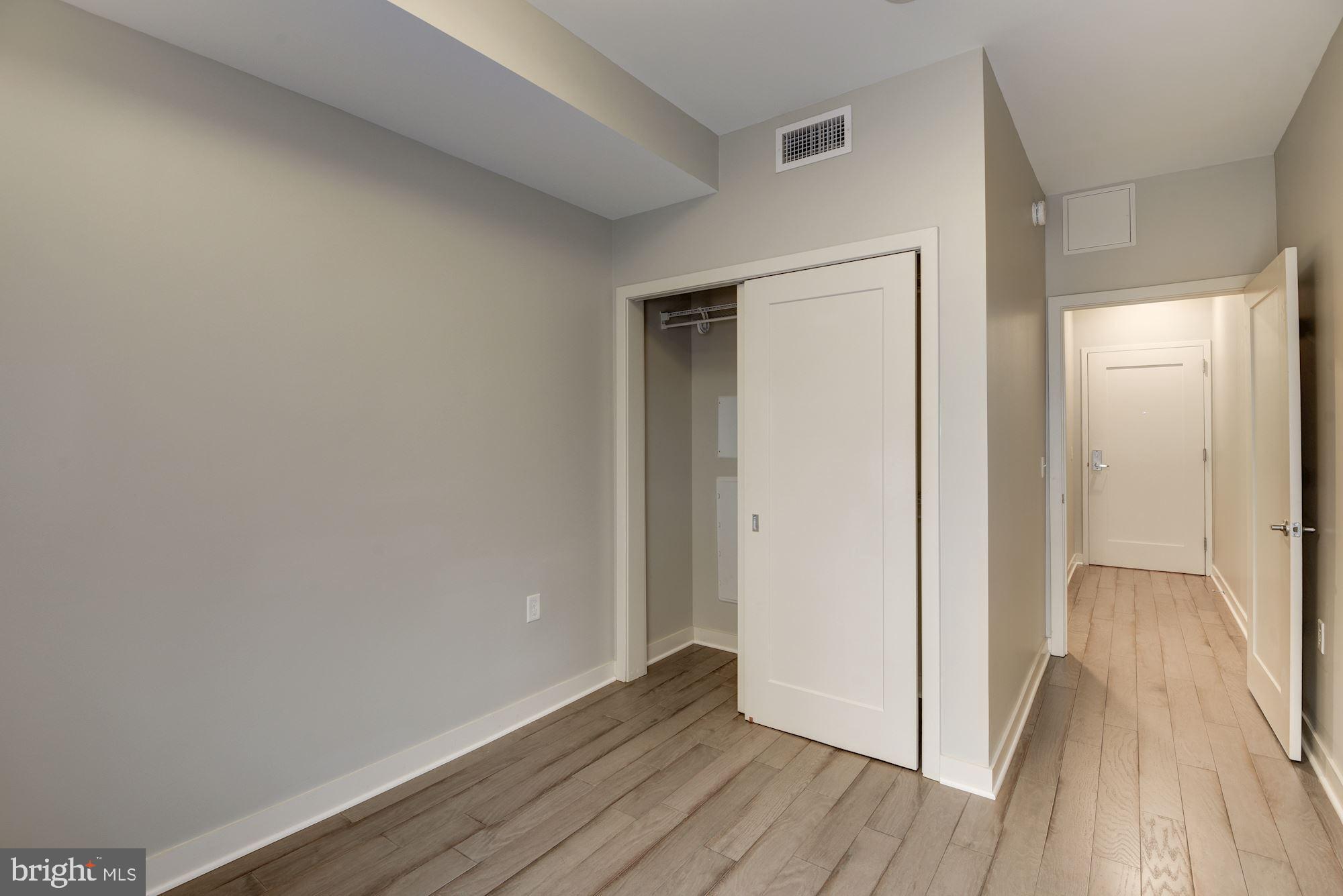 1320 Fenwick Lane, Unit 202 Silver Spring, MD 20910 - Photo 8 of 19 a view of a hallway with wooden floor