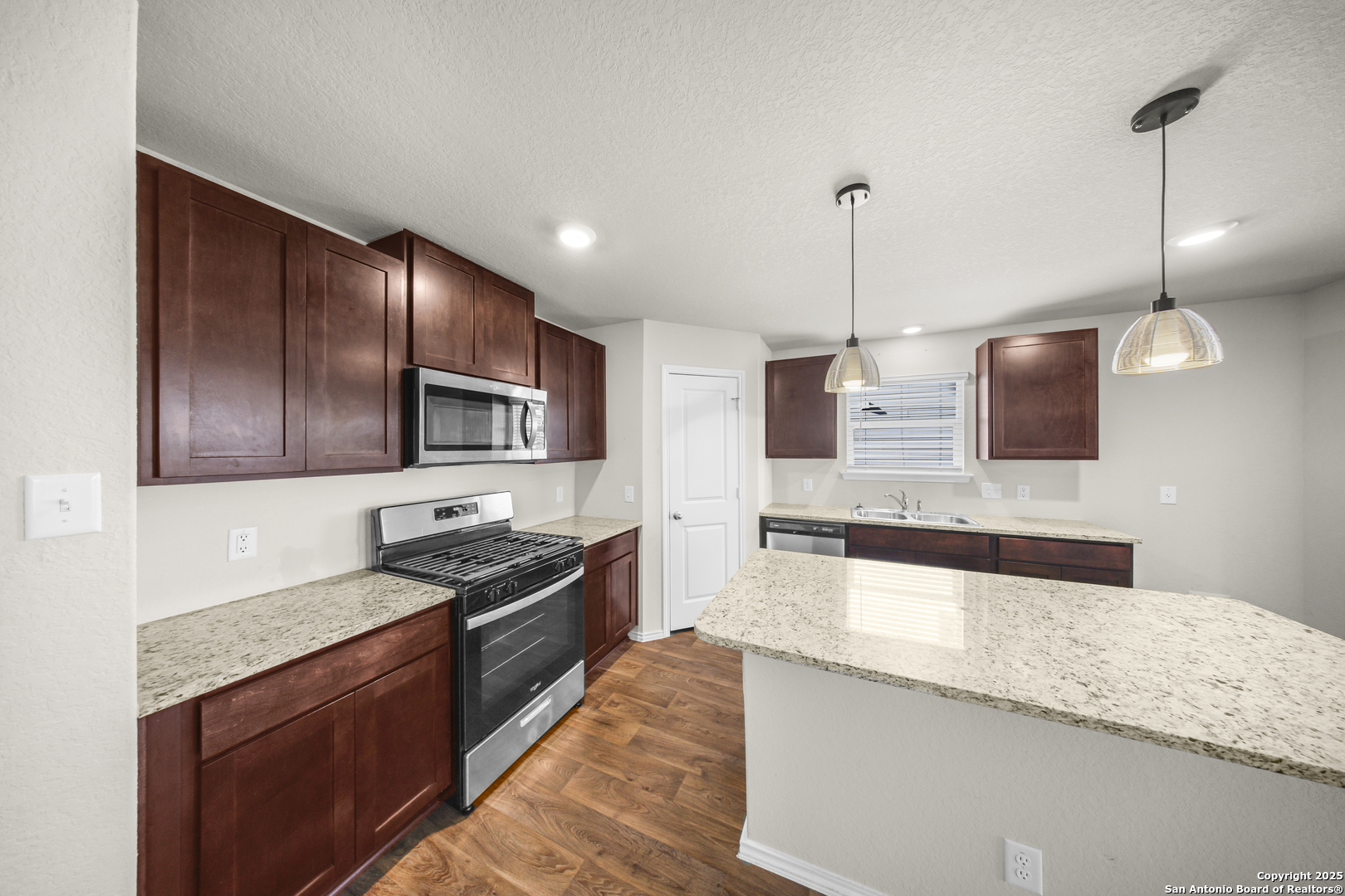 1023 Andean Emerald San Antonio, TX 78253 - Photo 4 of 19 a kitchen with stainless steel appliances granite countertop refrigerator a sink a stove and oven