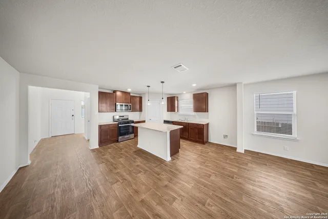 a living room with furniture and kitchen view
