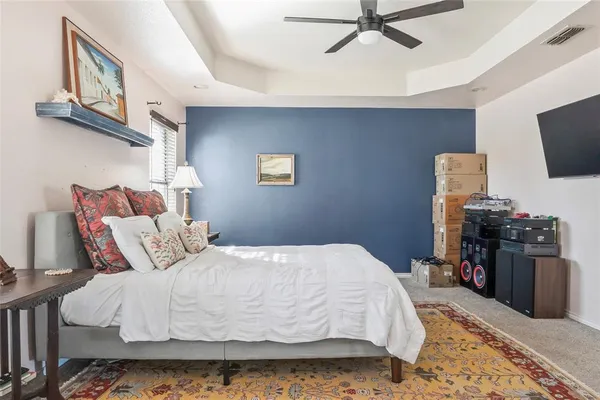 a bedroom with a bed and flat screen tv