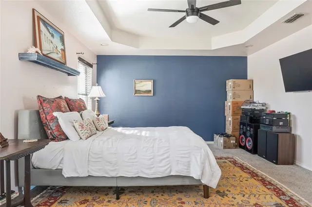 a bedroom with a bed and flat screen tv