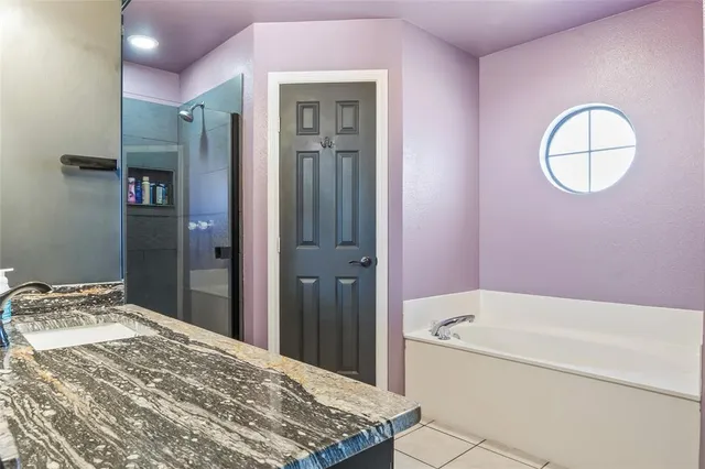 a bathroom with a tub and shower