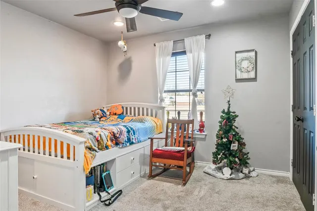a bedroom with furniture and a potted plant