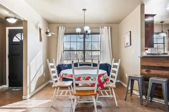 a dining room with furniture and window